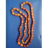 A Baltic amber graduated bead necklace of butterscotch colour, comprising 70 beads, the largest