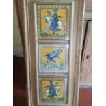 A framed display of three Victorian art pottery tiles by W. B. Simpson, depicting a lady on