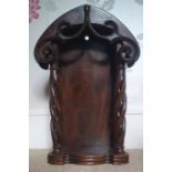 An antique carved wooden niche wall bracket, having a pair of open spiral twist side columns beneath