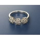 A modern triple cluster style diamond set 18ct white gold ring, total weight 0.50 carat.