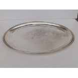 A plain Edwardian monogrammed oval silver salver - Birmingham 1910, 13.8" across.