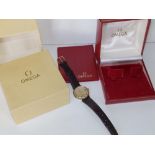 A boxed gent's gold plated Omega De Ville Automatic wrist watch with date indicator, on