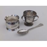 An Arts & Crafts style hammered silver egg cup, spoon & napkin ring - GNRH, Chester 1906. (3)
