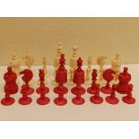 A 19thC red & white stained bone chess set, the kings 4" high. (32)