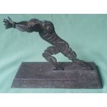 A late 19th/early 20thC iron sculpture depicting a slave, on rectangular base, 9.8" high.