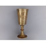 A 19thC Indian engraved brass goblet, having black enamelled panel decoration depicting figures &