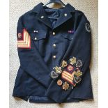 A blue military Corps of Commissionaires jacket with various insignias.