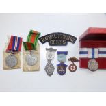 An RFC cloth badge and unrelated medals.