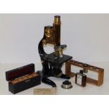 An early 20thC brass & black lacquered Ernst Leitz Wetzlar microscope with some accessories, 12"