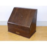 An oak slope-front stationery box.