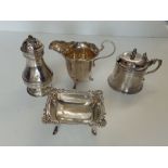 A Victorian silver mustard pot with repaired glass liner, a Birmingham silver cream jug, a Sheffield