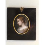 A 19thC oval enamelled porcelain miniature portrait of a young woman in profile, 3.1".