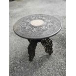 An Eastern inlaid & carved wood circular occasional table on folding stand, 21" diameter.