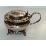 A William IV silver mustard pot with shell thumbpiece and feather gadrooned rim - JSAS, London 1834,