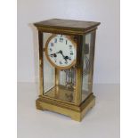 A four-glass gilt brass striking mantel clock with mercury pendulum, 10.75" high.