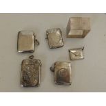 Four silver vesta cases, a square silver napkin ring and a stamp holder. (6)