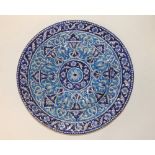 A 19thC Eastern blue & white circular wall plaque, the raised decoration of bands of arabesque