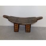 An African wooden stool, carved & black stained geometric decoration, 25" across - one leg
