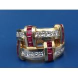 A ruby & diamond set 18K cocktail ring of modern double band form, set with numerous small