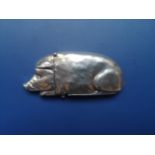 A silver vesta in the form of a recumbent pig, London import marks for 1949, 2.75" across.