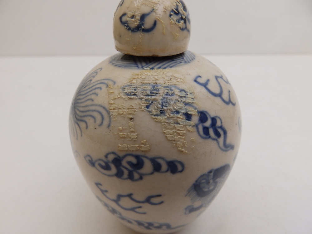 A small Chinese covered blue & white porcelain jar decorated with cavorting shishis amidst cloud - Image 3 of 7