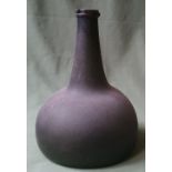 An antique glass onion-shape bottle, 7.75" high.