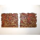 A small pair of Chinese red lacquered rectangular panels with gilding, carved decoration depicting