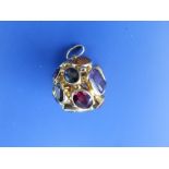 A tutti-frutti gem set ball pendant of open hollow form, comprising numerous collet set stones, 750,