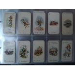 A collection of approximately 1,100 cigarette cards contained in two plastic albums, including