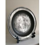 An antique continental pewter charger, 15" diameter.
