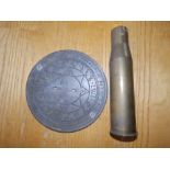 A reproduction brass sundial together with a 2" diameter brass shell case. (2)