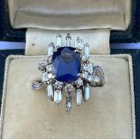 A certified natural 4.24 carat colour change Sri-Lankan sapphire & diamond cluster ring, the four-