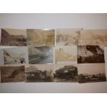 22 early photographic postcards showing storm damage to the railway and sea front at Teignmouth.