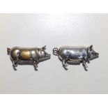 A small silver pig vesta, 2" across and a plated pig vesta. (2).