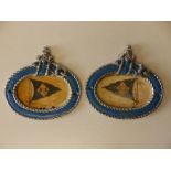 A small pair of painted metal maritime plaques, of oval form in gadrooned frames, showing blue flags