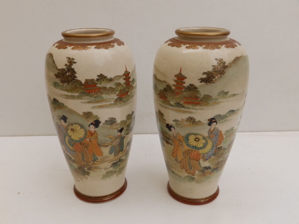 A signed pair of Japanese Meiji period earthenware Satsuma vases, of shouldered form, decorated with