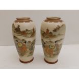 A signed pair of Japanese Meiji period earthenware Satsuma vases, of shouldered form, decorated with