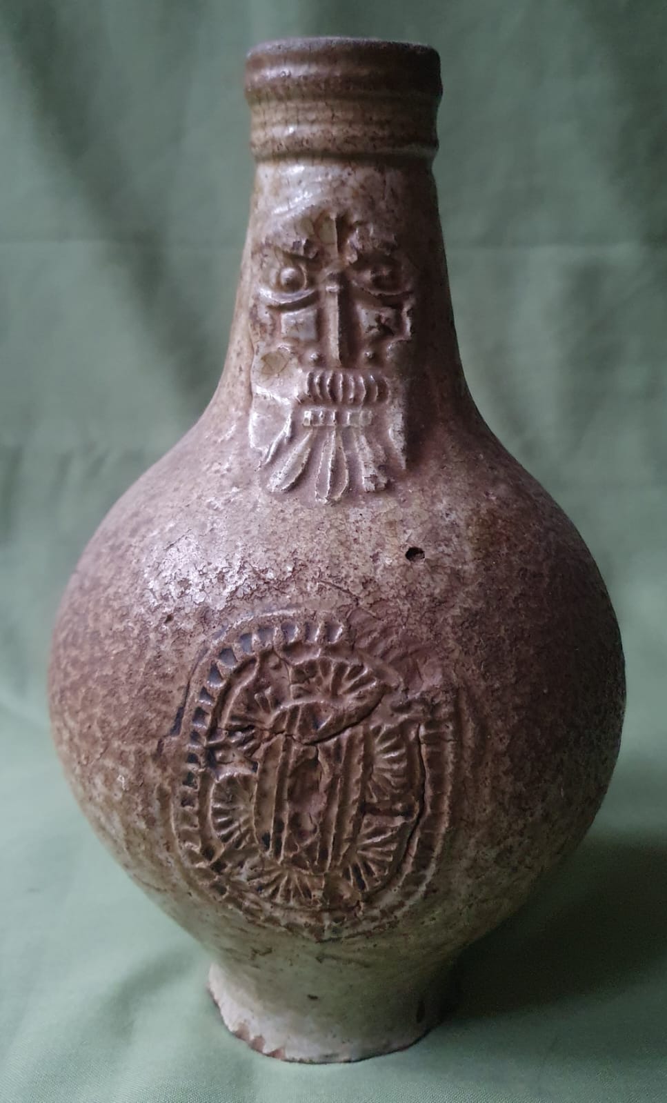 A 17thC bellarmine pottery jug of small proportions, 8.5" high.