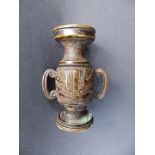 A small antique Chinese bronze two-handled vase, decorated with a stylised mask to each side and