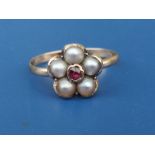 A Georgian pearl flowerhead cluster set gold ring with central garnet. Finger size N/O.