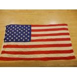 A large vintage silk US flag, approx. 8ft 6ins, together with a Japanese naval pennant, approx.