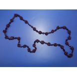 A garnet 'berry' necklace, the garnet beads strung into clusters along its length, 31".
