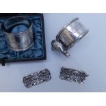 A cased pair of late Victorian silver napkin rings - Sheffield 1896, a silver napkin ring with a