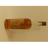 A bottle of John Dewar White Label whisky.