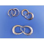 Three pairs of 375 metal hoop earrings. (6)