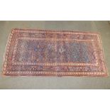 An old kelim weave Oriental rug, the field with rows of stepped lozenges, the borders of latch-