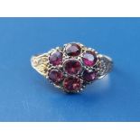 A 12ct gold red stone cluster ring - Birmingham marks.