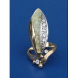 A diamond set & enamelled 750 yellow metal ring of bold leaf/insect design. Finger size I/J.