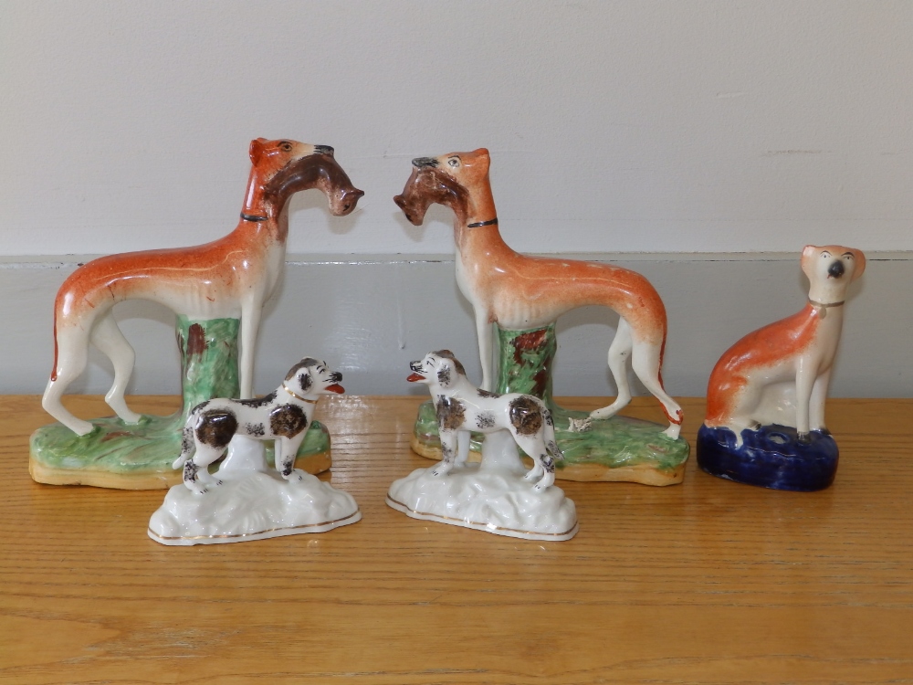 A pair of Victorian Staffordshire greyhounds with rabbits, 7.75" high and three other