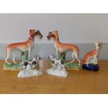 A pair of Victorian Staffordshire greyhounds with rabbits, 7.75" high and three other
